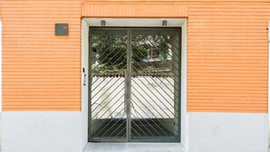 A building with a numbered door, a metal gate, and a brick wall. - Home at Hotel Naviglio - Sambuco Apt (Milan)