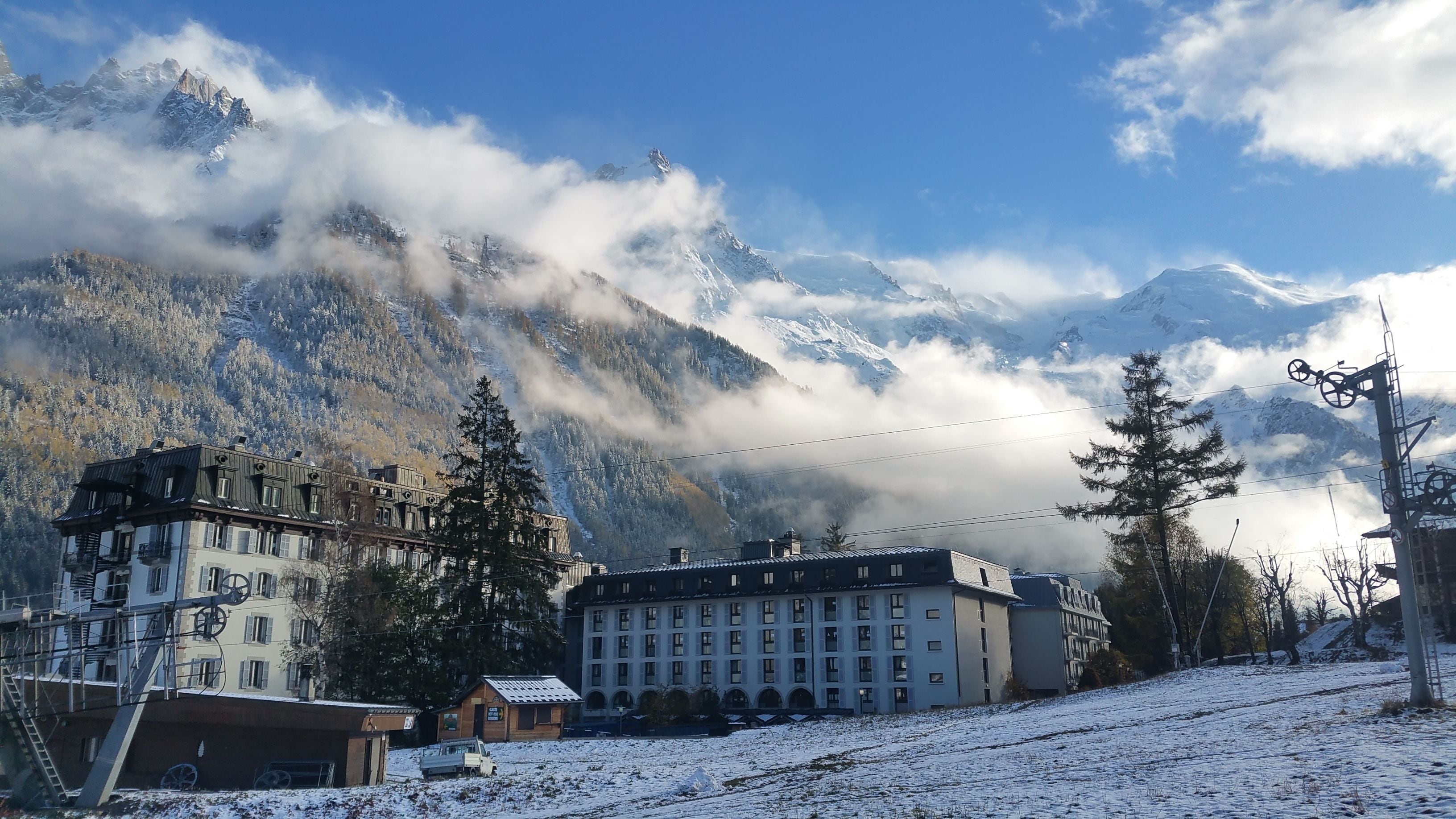 A hotel with a traditional European architectural style, featuring multiple floors and a prominent central building.