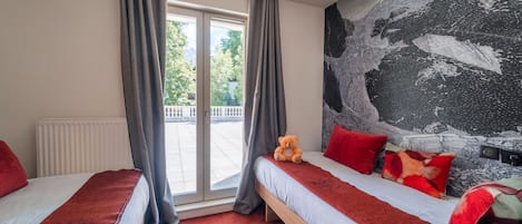 A hotel room with two beds, a large window with curtains, a teddy bear on one bed, and a large abstract painting on the wall.