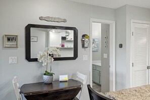 Enjoy a meal in this well-organized dining area with a table and chairs, a mirror, and a WiFi-enabled space.