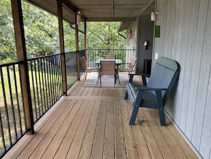 Enjoy al fresco dining and relaxation in this outdoor space with a table, chairs, and a bench, plus a cozy fireplace.