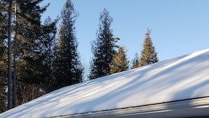 A single-story building with a snow-covered roof, a front door, and two windows. - Rothesay Motel (Rothesay)