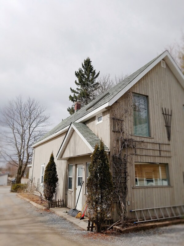 A two-story house with a gabled roof, a chimney, and a front porch. - Rothesay Motel (Rothesay)