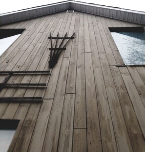 A wooden sloped roof with a metal gutter system. - Rothesay Motel (Rothesay)
