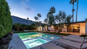 A modern outdoor pool area with lounge chairs, a hot tub, and a well-lit patio. - Rare Find: Home + Private Casita | Pool & Spa (Palm Springs)