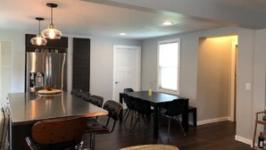 A modern kitchen with a large island, stainless steel appliances, and pendant lighting. - Walking distance to downtown Elk Rapids, Elk Lake and dining (Elk Rapids)