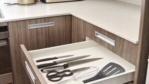 A kitchen with a drawer containing kitchen utensils, a toaster, and a kettle on the countertop. - Armagh Apartment 3 - Central Christchurch (Christchurch)