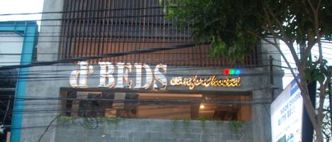 A building with a sign reading "Beds" and a visible entrance.