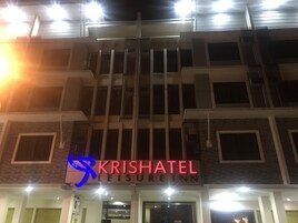 A building with a sign reading "KRISHATEL LEISURE INN".