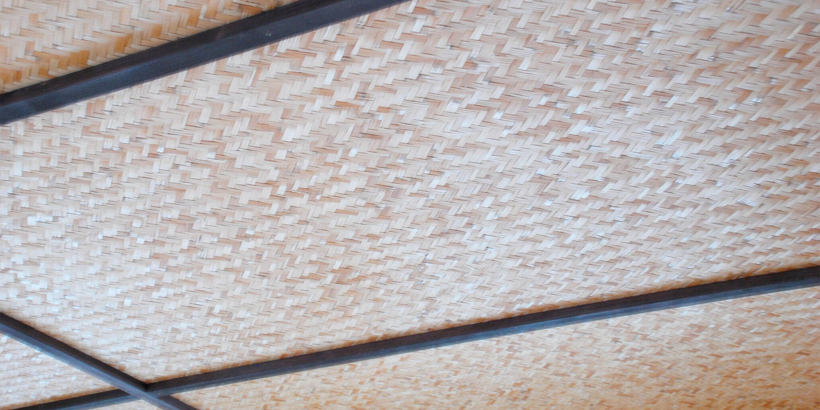A woven mat with a grid pattern, likely part of a room's flooring or ceiling.