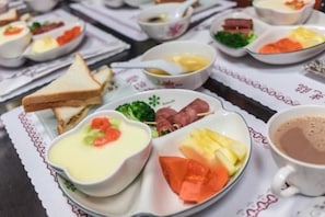 A table with various food items, including soup, fruit, and sandwiches. - Gen Product B&B (New Taipei City)