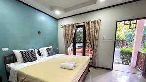 A hotel room with a bed, a window with curtains, and a view of the outside. - Saithong Resort (Udon Thani)
