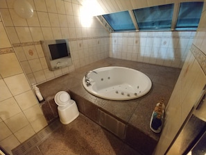 A bathroom with a large bathtub, a toilet, and a sink. - Hotel Allure Nagoya - Adults Only (Nagoya)