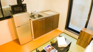 A compact kitchenette with a microwave, sink, and refrigerator. - GH One More Heart Jujo 1 (Kyoto)