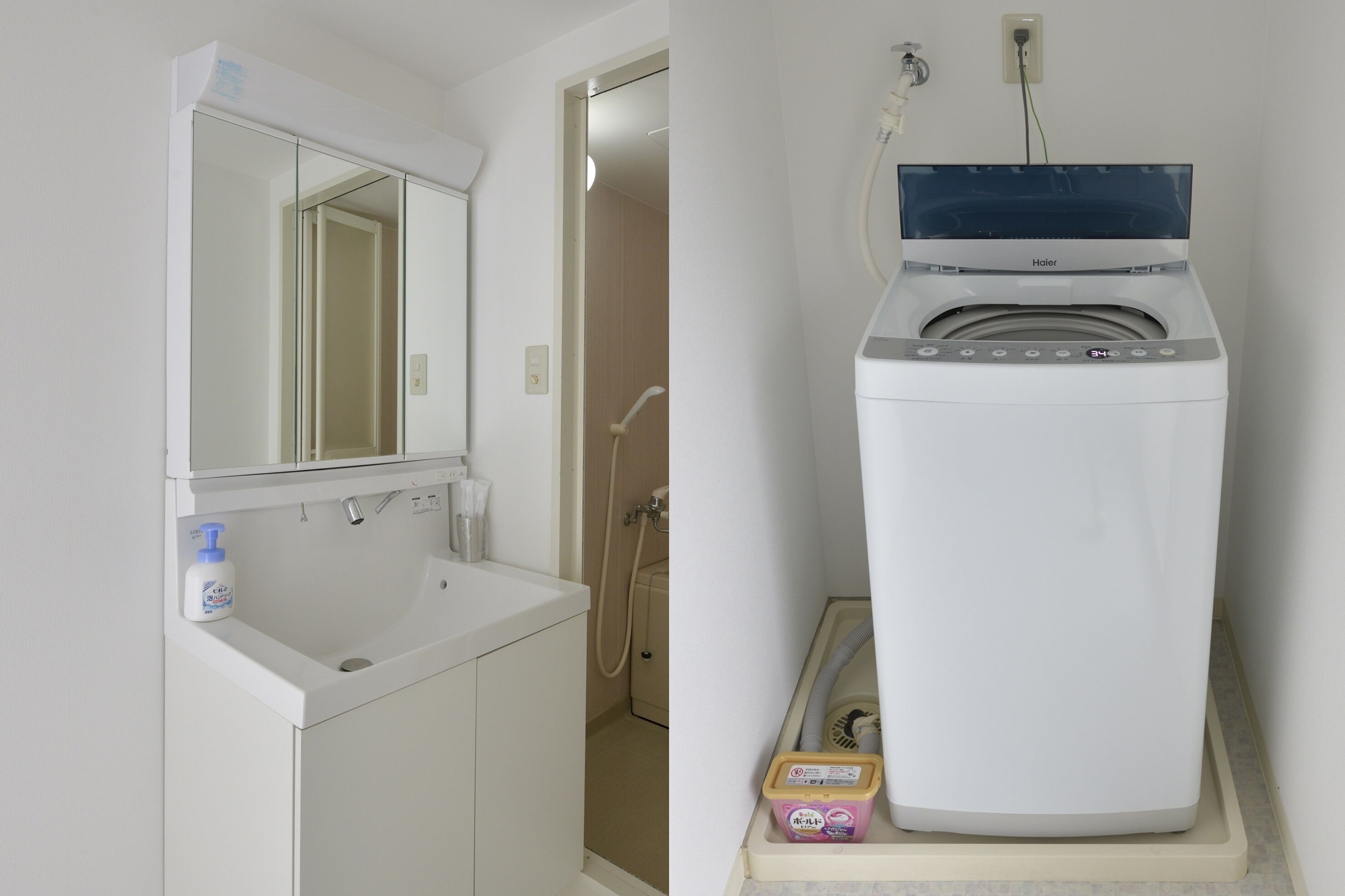 A bathroom with a white sink, mirror, and a front-loading washer and dryer.