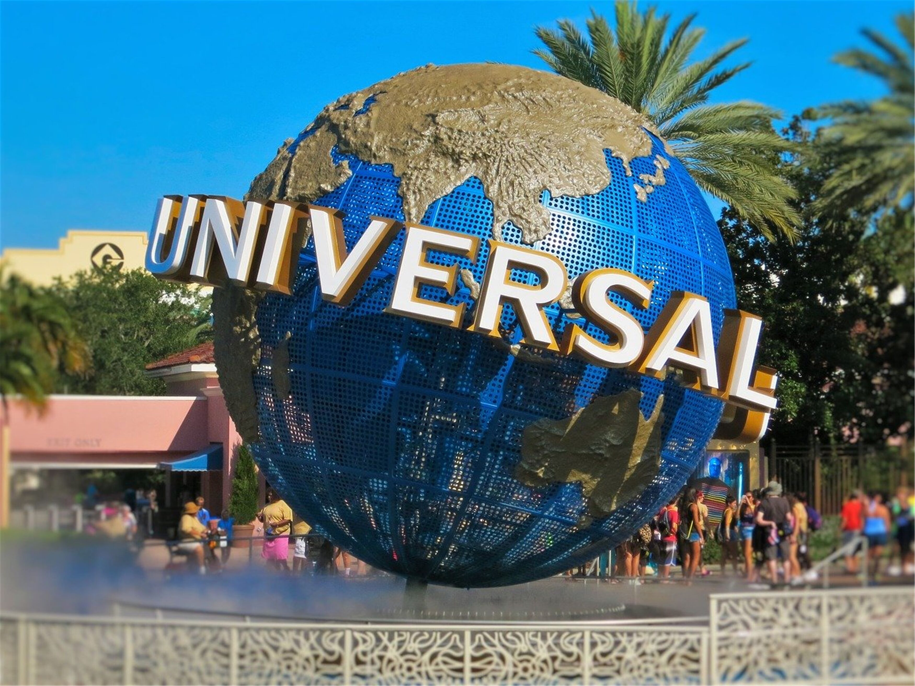 A large globe with "UNIVERSAL" written on it, surrounded by a decorative fence.