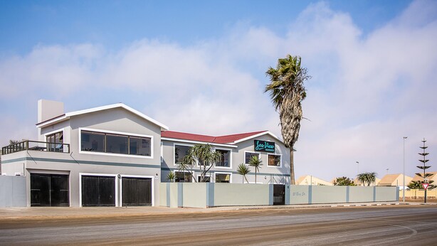 A two-story building with a red roof, large windows, and a sign that reads "Sea View." - Sea View Backpackers - Hostel (Swakopmund)
