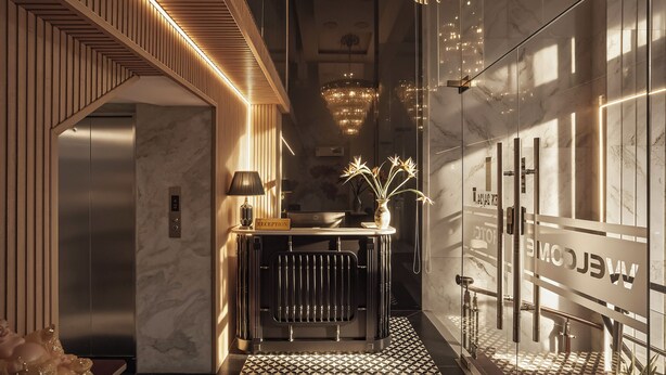 A modern reception area with a marble floor, a reception desk, a radiator, and a chandelier. - The Passion Suite Hotel (Ho Chi Minh City)