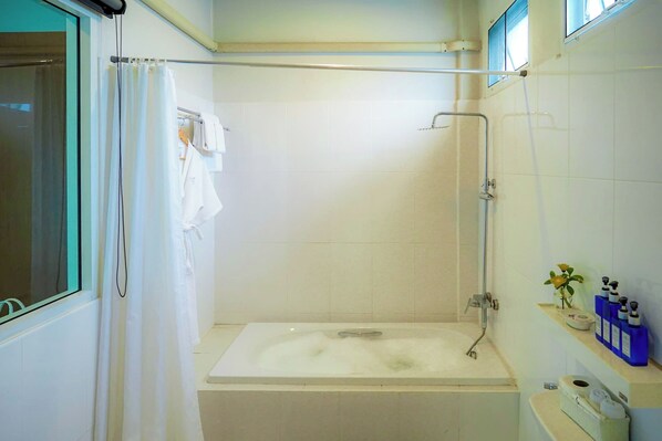 Un baño con bañera, ducha e inodoro.