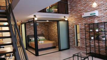 Deluxe Duplex Suite | Living area | Flat-screen TV