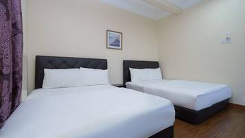 A hotel room with two beds, a ceiling with a decorative molding, a framed picture on the wall, and a thermostat on the wall.