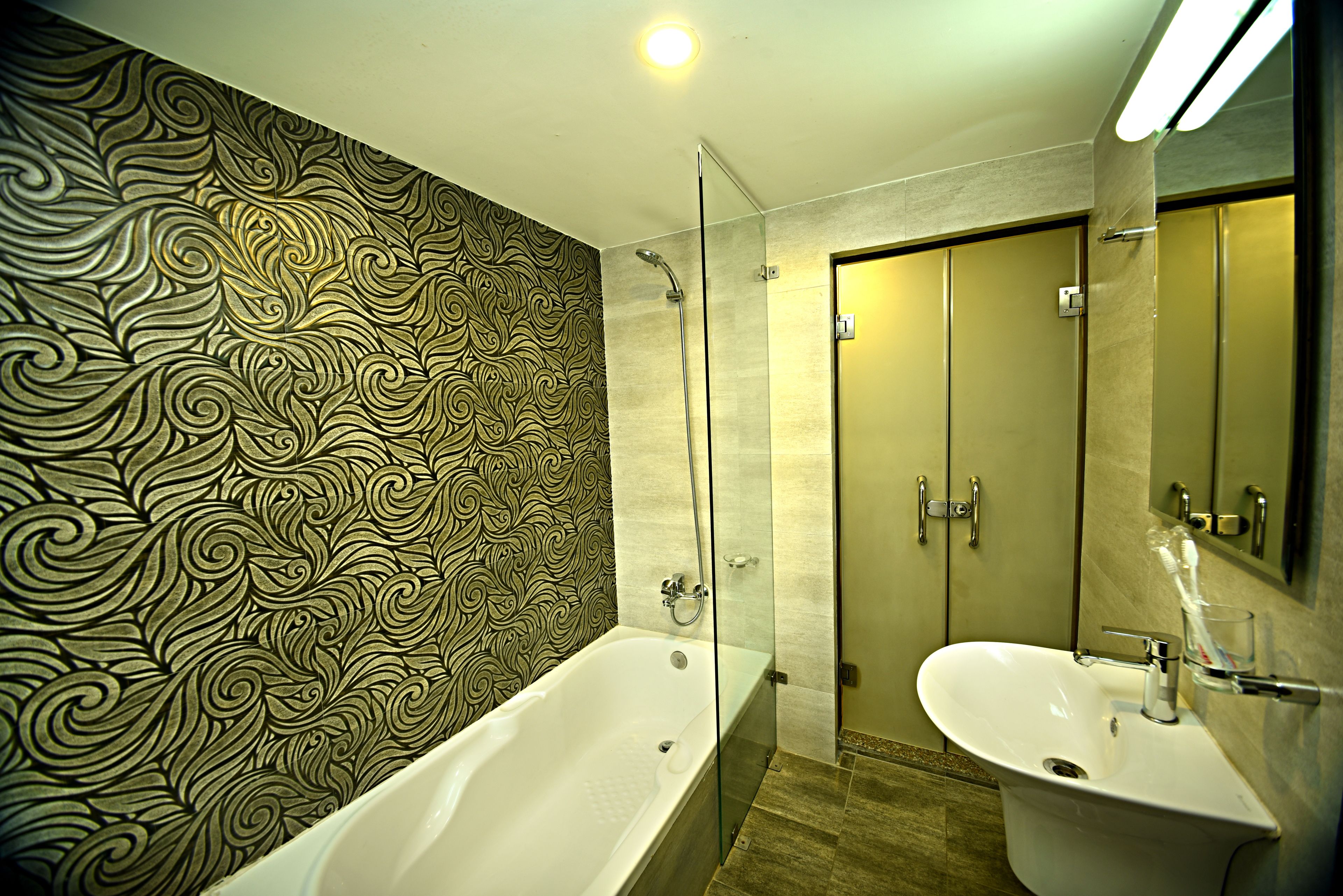 junior suite | bathroom | shower, rainfall showerhead, slippers, towels