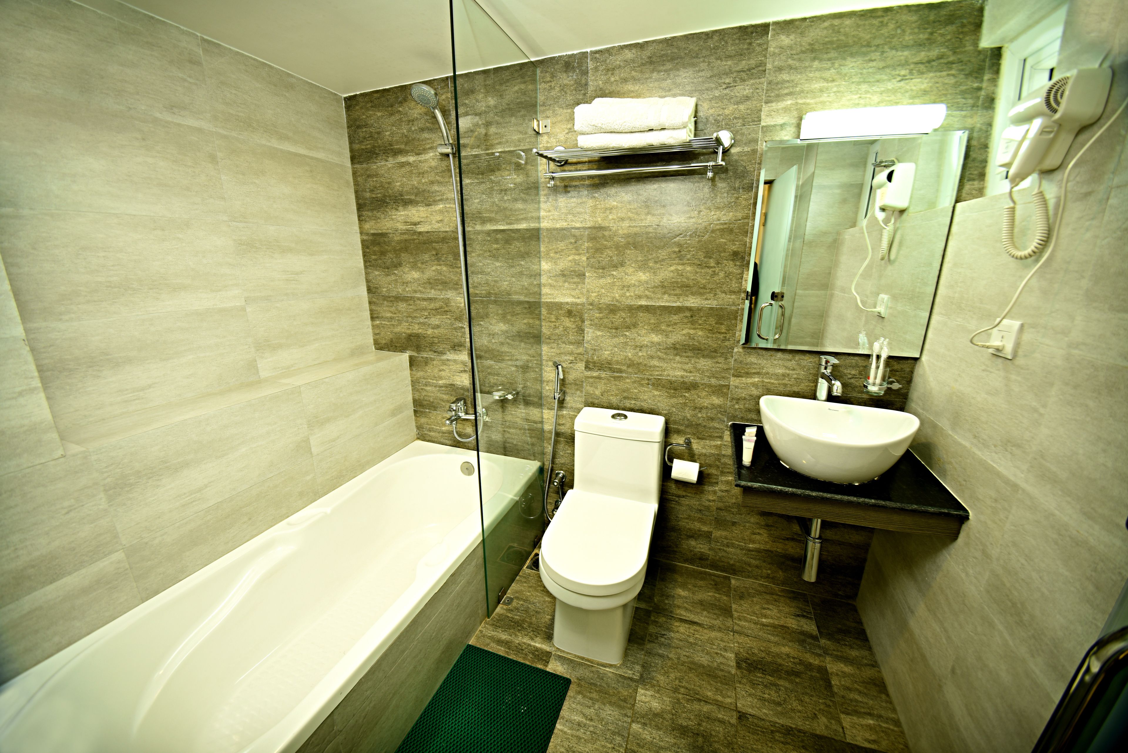 deluxe suite | bathroom | shower, rainfall showerhead, slippers, towels