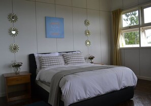 Desk, iron/ironing board, bed sheets