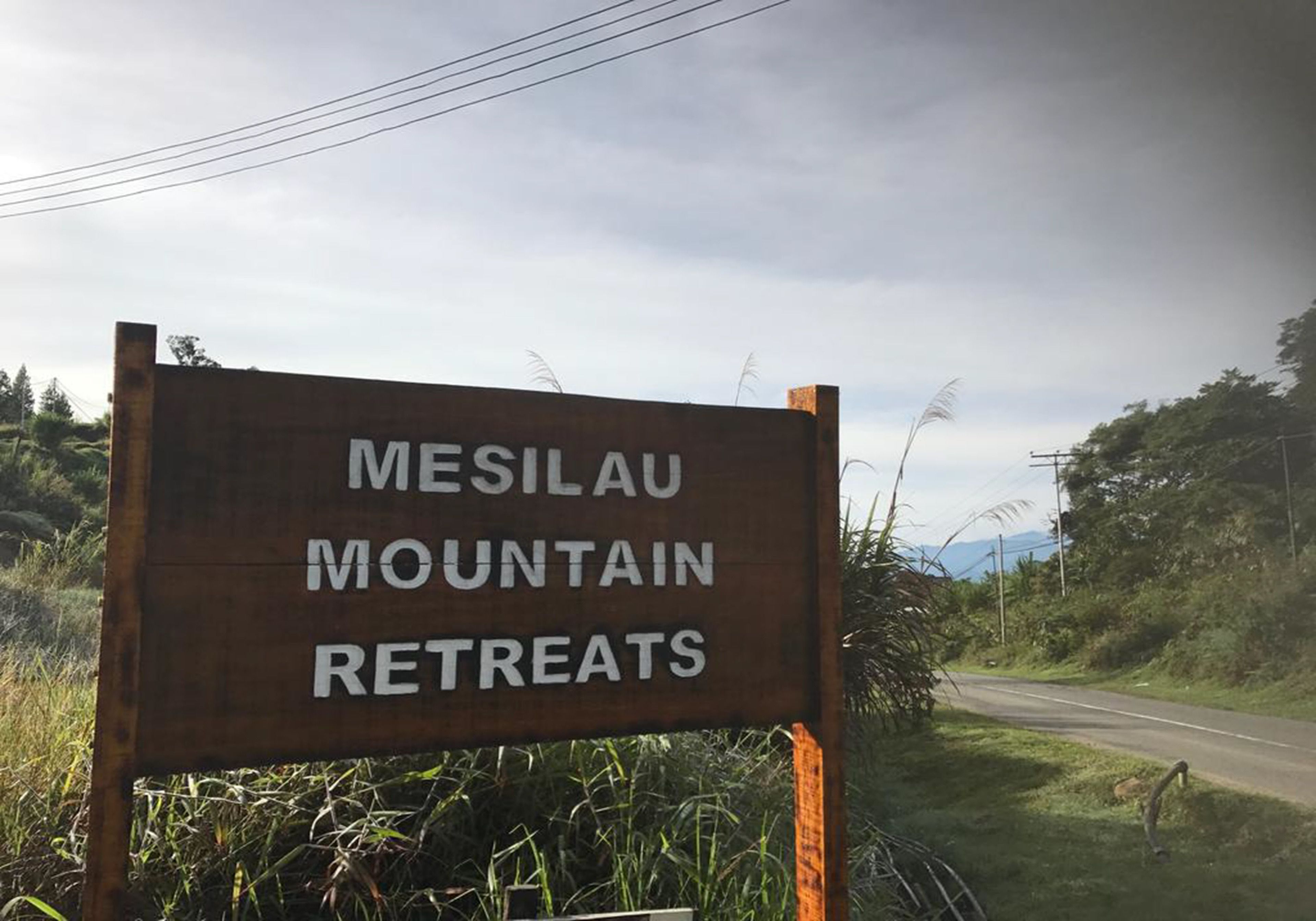 A wooden sign with the text "MESILAU MOUNTAIN RETREATS".