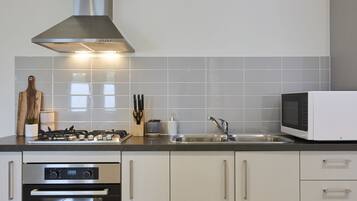 Townhome, 2 Bedrooms | Private kitchen | Full-size fridge, microwave, oven, stovetop