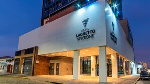 A hotel with a modern facade, large glass entrance, and a prominent logo. -  Laghetto Rio Grande (Rio Grande)