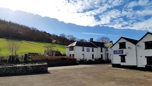 A white building with a sign reading "The Kestrel Inn" indicating it is a restaurant and rooms. - The Kestrel B&B (Crickhowell)