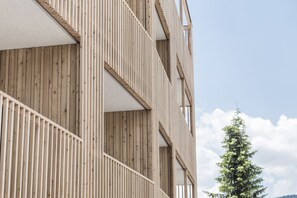 A multi-story building with a wooden facade and balconies. - Hotel Ambet (Rio di Pusteria)