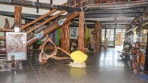A spacious interior with a high ceiling and exposed wooden beams.