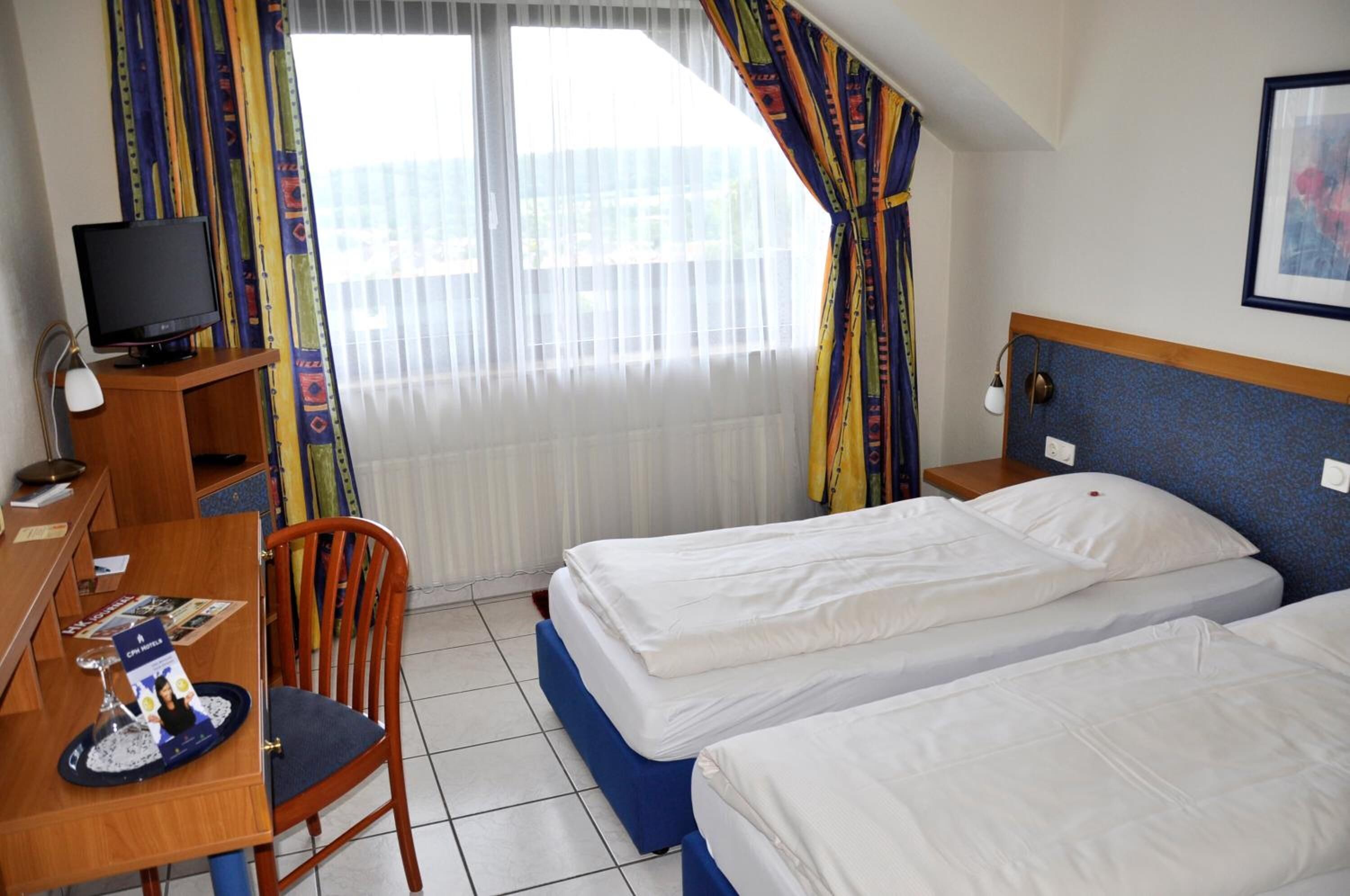 desk, blackout curtains, soundproofing, rollaway beds