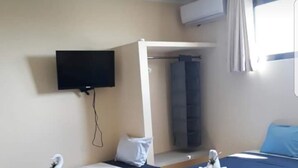 A hotel room with two single beds, a TV mounted on the wall, and a window with curtains. - Studios Siena Av CTM, colonia Zazil Ha (Playa del Carmen)