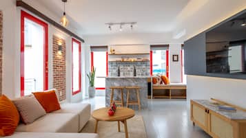 Family Suite | Living area | 55-inch flat-screen TV with satellite channels