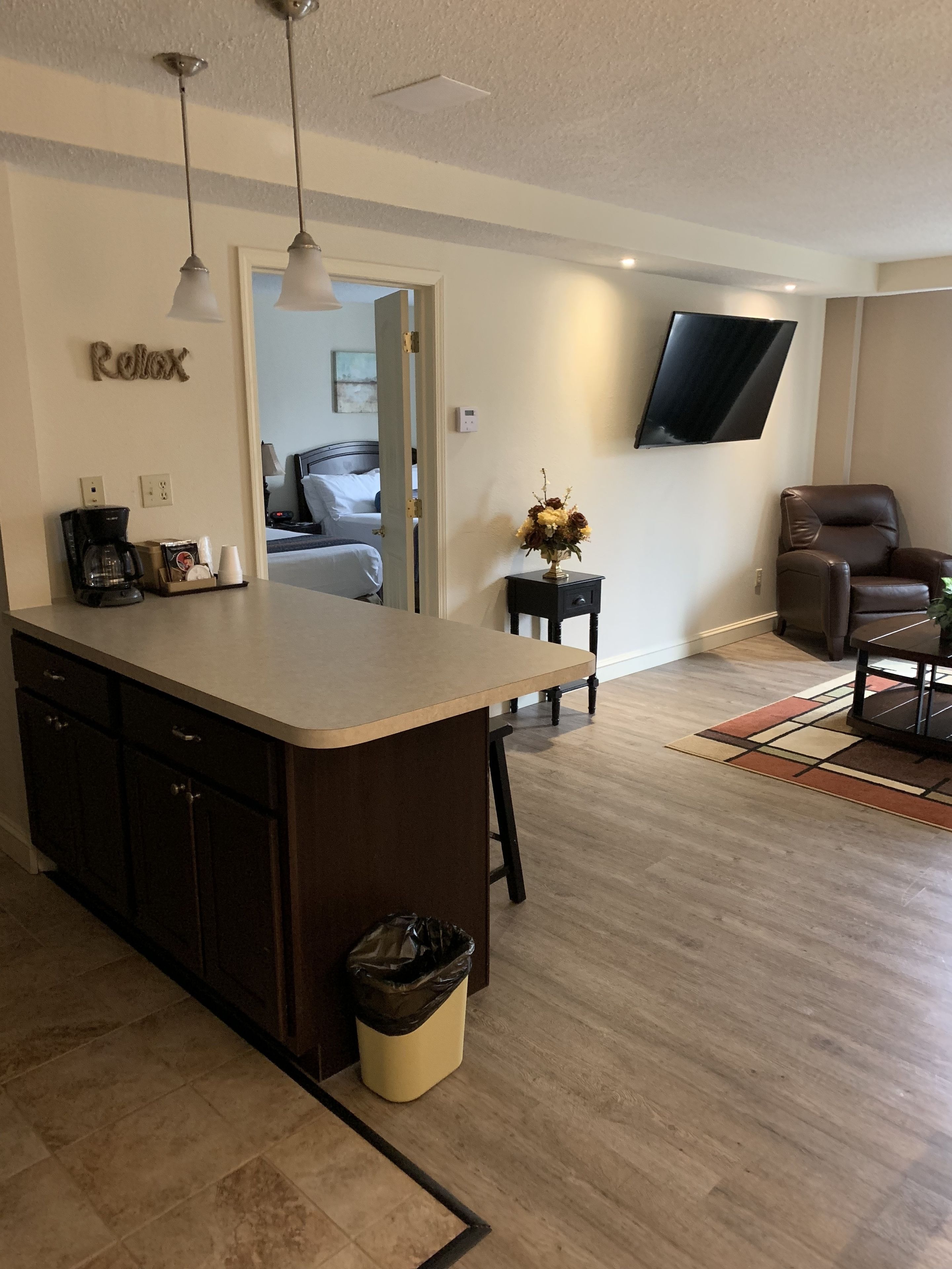 deluxe suite 2 double beds | living area | 55-inch smart tv with cable channels, tv