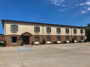 A two-story building with a parking lot in front.