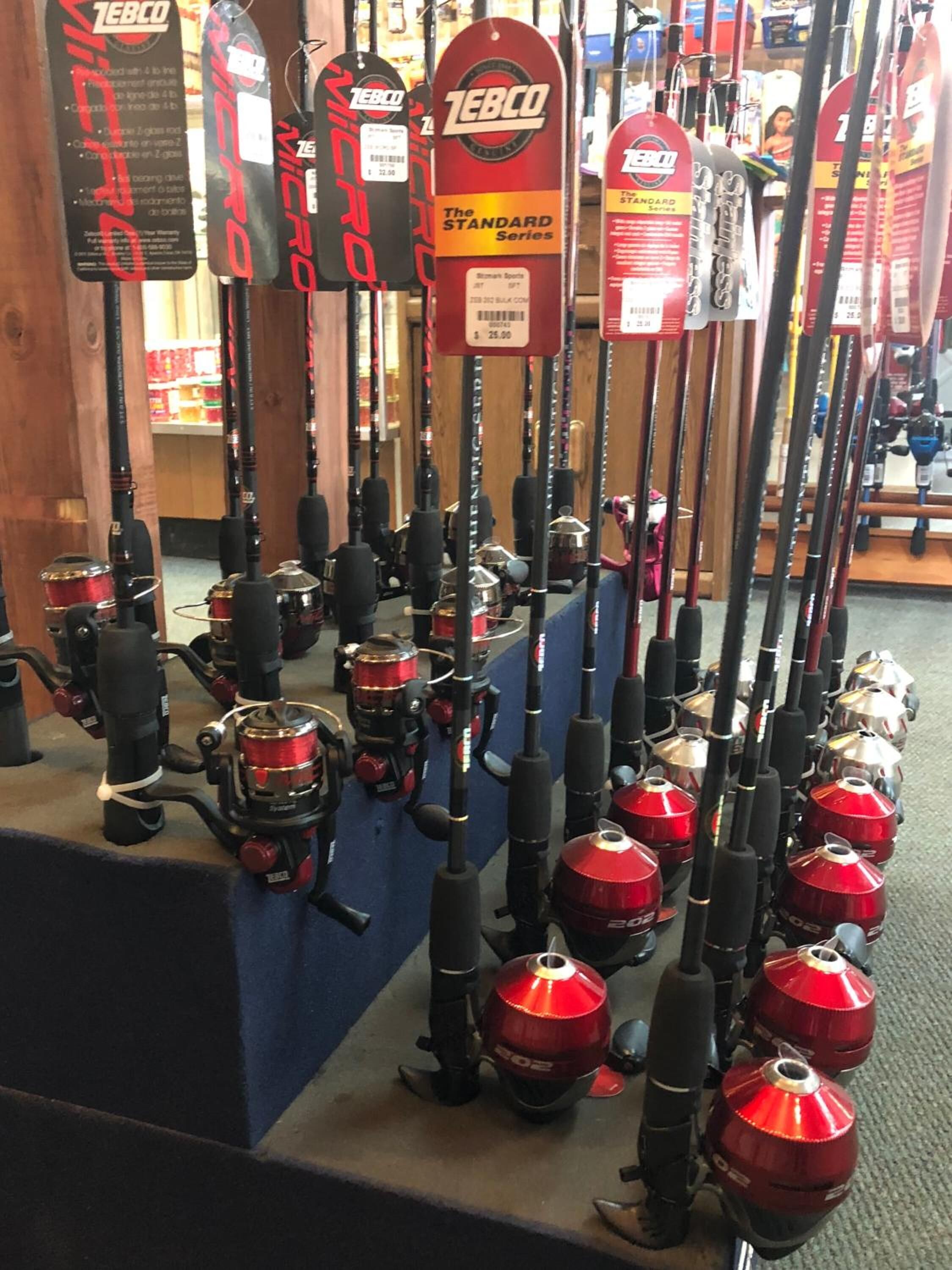 A display of fishing rods and reels in a store.