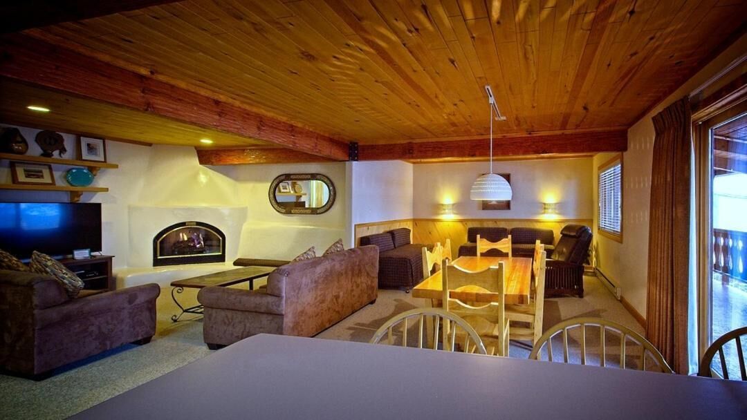 A cozy living room with a fireplace, comfortable seating, and a television.