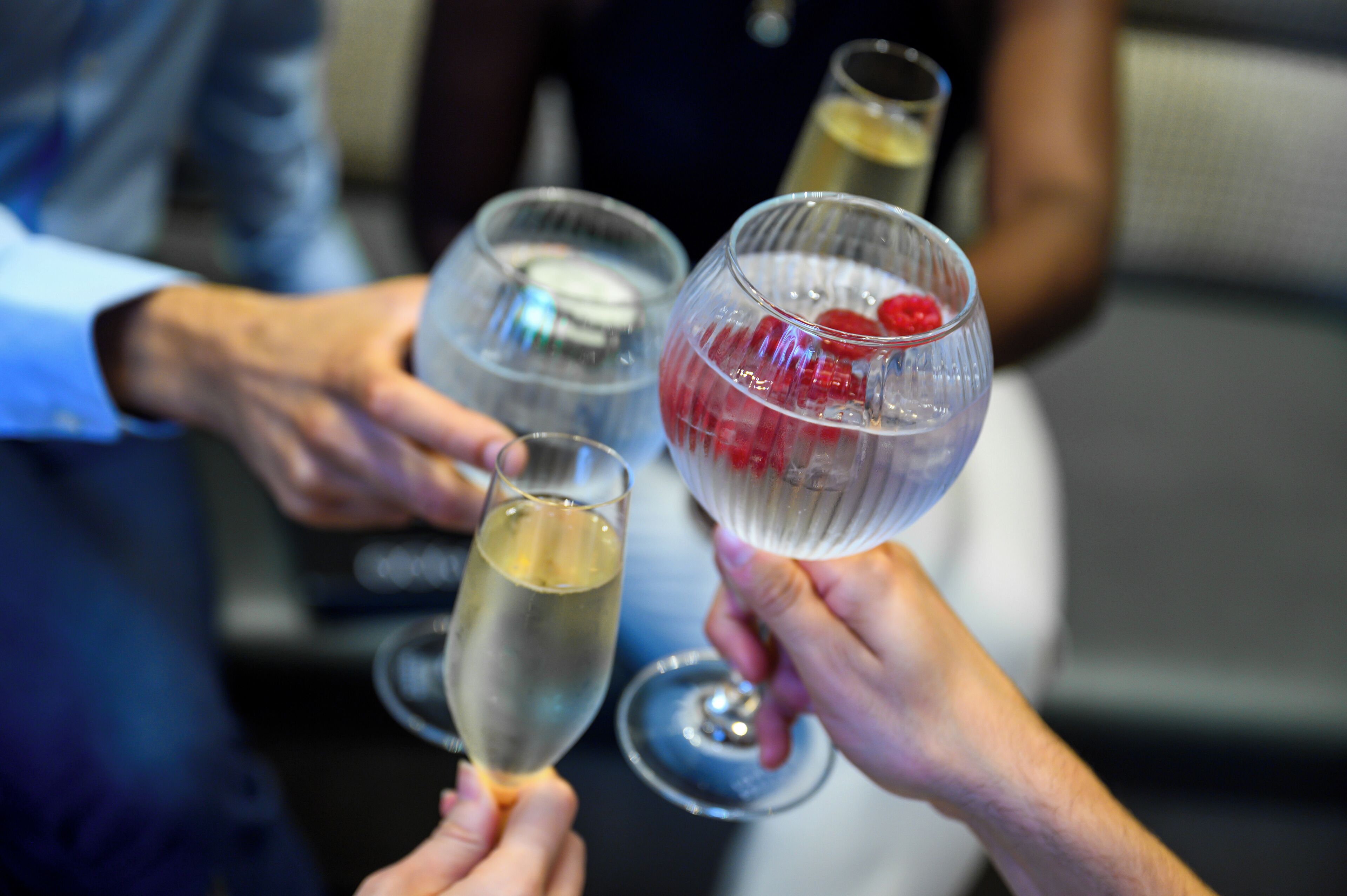 A group of people holding champagne glasses.