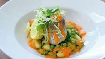 A plate of food with vegetables and a garnish.