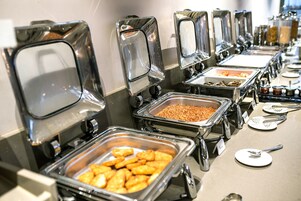 A buffet with multiple self-service stations, each with a variety of food items.