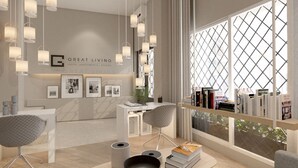 A modern hotel lobby with a reception desk, seating area, and a large window with a view. - Great Living Koukaki (Athens)
