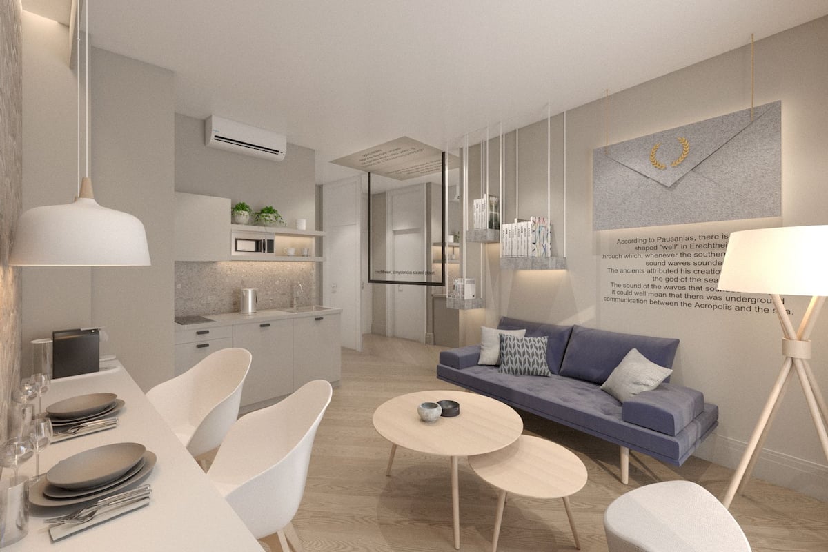 A modern living room with a sofa, coffee table, and dining area.