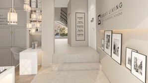 A modern hotel lobby with a staircase leading to the upper floors. - Great Living Koukaki (Athens)