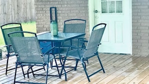 A wooden deck with a table and chairs. - Alleyne's Place (Hitchcock)