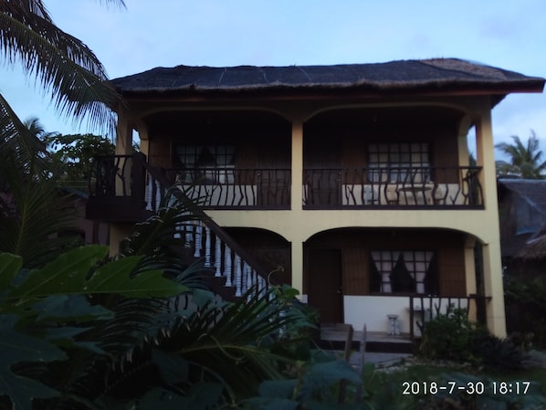 A two-story building with a balcony on the upper floor.