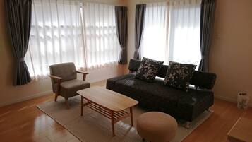 2 Bedroom Apartment | Living area | Flat-screen TV